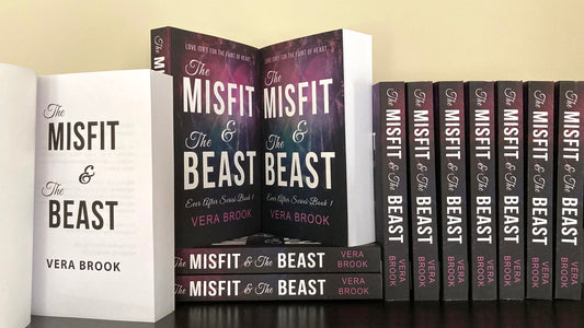 A bookshelf filled with paperbacks of The Misfit and The Beast, a young adult romance by Vera Brook. 
